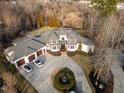 Expansive home featuring a circular driveway, attached three-car garage, and a well-manicured lawn at 1326 Lochshire Dr, Burlington, NC 27215