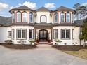 Striking home exterior featuring arched windows, double-door entrance, and decorative landscaping at 1326 Lochshire Dr, Burlington, NC 27215