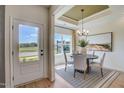 Bright dining room with stylish chandelier, large window and outdoor view at 135 Baneberry Dr, Broadway, NC 27505