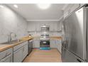 Modern kitchen features wood countertops, stainless steel appliances, and a tiled backsplash at 1411 Rosewood St, Durham, NC 27701
