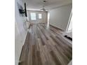 Open living area with hard surface floors, a ceiling fan, neutral paint, and access to the exterior at 1440 Collegeview Ave # 301, Raleigh, NC 27606