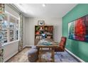 Bright home office with a large window, contemporary desk, vibrant artwork, and a comfortable seating area at 149 Ethel Ln, Angier, NC 27501