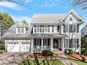 Beautiful two-story home with a covered front porch, two-car garage, and well-maintained landscaping at 1617 Heritage Club Ave, Wake Forest, NC 27587