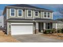 Inviting two-story home featuring a two-car garage and charming covered porch with decorative columns at 2000 Muddy Creek Ct, Raleigh, NC 27610