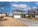 Traditional home with a two-car garage, covered front porch, and large front yard at 2000 Muddy Ct, Raleigh, NC 27610