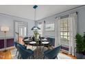 Elegant dining room with contemporary light fixture, stylish seating, and abundant natural light at 2001 Carrington Dr, Raleigh, NC 27615