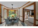 Bright dining area with large bay window and elegant chandelier fixture provides a lovely space at 2001 Carrington Dr, Raleigh, NC 27615