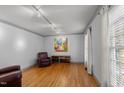 Cozy living room featuring hardwood floors, ample light, neutral paint, and comfortable furnishings at 2001 Carrington Dr, Raleigh, NC 27615