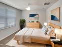 This staged bedroom features neutral tones and a light wood bedframe and dresser at 2005 Silent Bend Dr, Durham, NC 27704