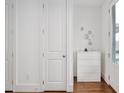 Bright hallway featuring hardwood floors, a large closet, and modern accents at 2098 Great Ridge Pkwy, Chapel Hill, NC 27516