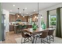 Bright dining area adjacent to the kitchen featuring a modern table setting and lots of natural light at 219 E American Merigold Dr # 45, Benson, NC 27504