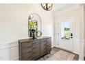 Inviting foyer featuring a stylish console table, mirror, and decorative lighting, leading into the home at 219 E American Merigold Dr # 45, Benson, NC 27504