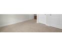 Comfortable bedroom with neutral carpet, white trim, and closet doors visible in the frame at 273 Umstead St, Sanford, NC 27330