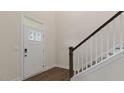 Inviting entryway featuring a staircase with white banisters, a modern front door, and hardwood flooring at 277 Umstead St, Sanford, NC 27330