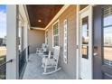 Charming front porch features rocking chairs and a stained wood ceiling at 29 Alban Row, Fuquay Varina, NC 27526