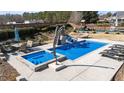 Backyard pool and hot tub combo, surrounded by lounge chairs, patio furniture and a playset at 29 Alban Row, Fuquay Varina, NC 27526