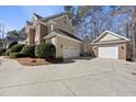 View of a spacious driveway leading to a two-car garage and a detached garage, perfect for extra storage at 3604 Heritage Creek Dr, Apex, NC 27539