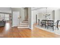 Inviting foyer with hardwood floors, staircase, and dining room, creating a warm and welcoming entrance at 3604 Heritage Creek Dr, Apex, NC 27539