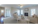 Bright living room with a fireplace, large windows, and plush carpet at 3671 Coach Lantern Ave, Wake Forest, NC 27587