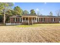 Charming red brick home featuring a welcoming front porch and a well-manicured lawn at 41 E T Hanner Rd, Bear Creek, NC 27207
