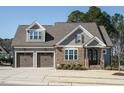 Beautiful gray home featuring a stone facade and inviting double garage at 429 Teague St, Wake Forest, NC 27587