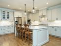 Bright kitchen featuring an island with seating, stainless steel appliances, and stylish pendant lighting at 429 Teague St, Wake Forest, NC 27587