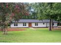 Charming home with a well-manicured lawn and beautiful trees at 4705 Bernie Pl, Raleigh, NC 27616
