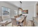 Bright dining room features a wooden table with upholstered chairs and a modern light fixture at 492 Arlie Ln, Lillington, NC 27546