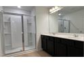 Contemporary bathroom featuring double vanity, quartz countertops, and a glass enclosed shower at 5004 Cambrey Dr # 3, Durham, NC 27703