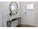 Bright foyer featuring a mirror, console table, and a white front door with glass panes at 602 Andrade Dr, Fuquay Varina, NC 27526