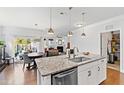Bright kitchen with stainless steel appliances, granite countertops, open to dining area with backyard view at 7525 Poplar Meadow Ln, Raleigh, NC 27616
