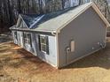 Side view of a newly constructed house with light blue siding and a grey roof at 810 Jasmine Rd, Fuquay Varina, NC 27526