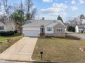 Beautiful single-Gathering home featuring a two-car garage, manicured lawn, and lovely brick accents on the exterior at 100 W Acres Cres, Cary, NC 27519