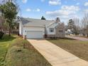 Spacious home featuring an extra long driveway, well-maintained lawn, and attached two-car garage at 100 W Acres Cres, Cary, NC 27519