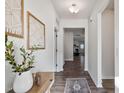 Bright hallway featuring stylish decor, wood floors, and a view into the living room at 1008 Sandtrap Way, Durham, NC 27703