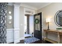 Inviting foyer with dark wood floors, decorative mirrors, and view to the front porch at 106 Rolling Meadows Ln, Chapel Hill, NC 27517