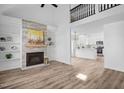 Open-concept living room with fireplace flowing into a modern white kitchen, perfect for entertaining at 107 Kingsmill Rd, Cary, NC 27511