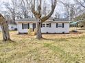 Inviting single-story home with light gray siding, black shutters, new front porch, and well-maintained front yard at 108 Torain St, Hillsborough, NC 27278