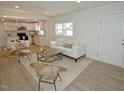 Open floor plan of a living room featuring lots of sunlight and vinyl flooring at 108 Torain St, Hillsborough, NC 27278