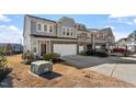 Attractive two-story home with a well-manicured lawn and a spacious driveway with a parked car at 110 Cambria Ln, Morrisville, NC 27560