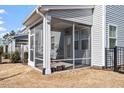 View of the screened in porch that offers ample space for outdoor furniture and relaxation at 110 Cambria Ln, Morrisville, NC 27560