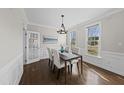 Bright dining room featuring classic decor and wainscoting details at 126 Claire Dr, Clayton, NC 27520