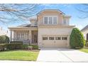 Inviting two-story home with brick facade, attached garage and well-maintained landscaping at 1324 Vanagrif Ct, Wake Forest, NC 27587