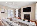 Bright living room features hardwood floors, fireplace, custom built-ins, and a large TV for entertainment at 1324 Vanagrif Ct, Wake Forest, NC 27587