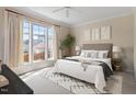 Serene main bedroom with large windows, plush carpet, neutral décor, and stylish furnishings for comfort at 1324 Vanagrif Ct, Wake Forest, NC 27587