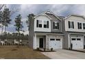 Charming two-story townhome with stone accents and an attached one car garage at 141 Rolesville Ridge Drive Dr, Rolesville, NC 27571