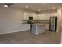 Open kitchen with white cabinets, stainless appliances, granite countertops, and island at 141 Rolesville Ridge Drive Dr, Rolesville, NC 27571