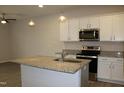 Bright kitchen features white cabinets, stainless appliances, granite countertops, and island with sink at 141 Rolesville Ridge Drive Dr, Rolesville, NC 27571