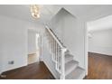 Bright foyer featuring a staircase with carpeted treads and light-colored wood flooring at 2004 Beecham Cir, Raleigh, NC 27607