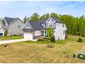 Exterior angle showing a two-story home with blue and gray siding and a large grassy yard at 201 Northview Dr, Middlesex, NC 27557